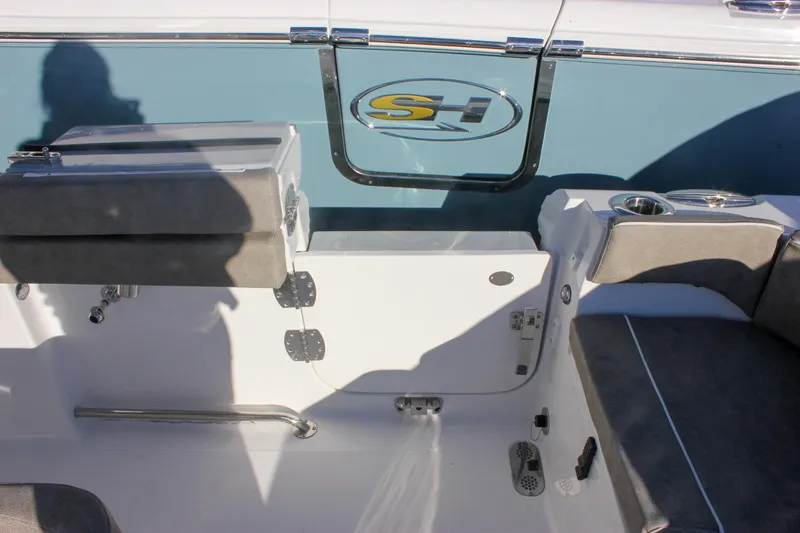 Slide: The Image of 2026 Sea Hunt Ultra 265 SE boat interior with seating and cup holders. - 19