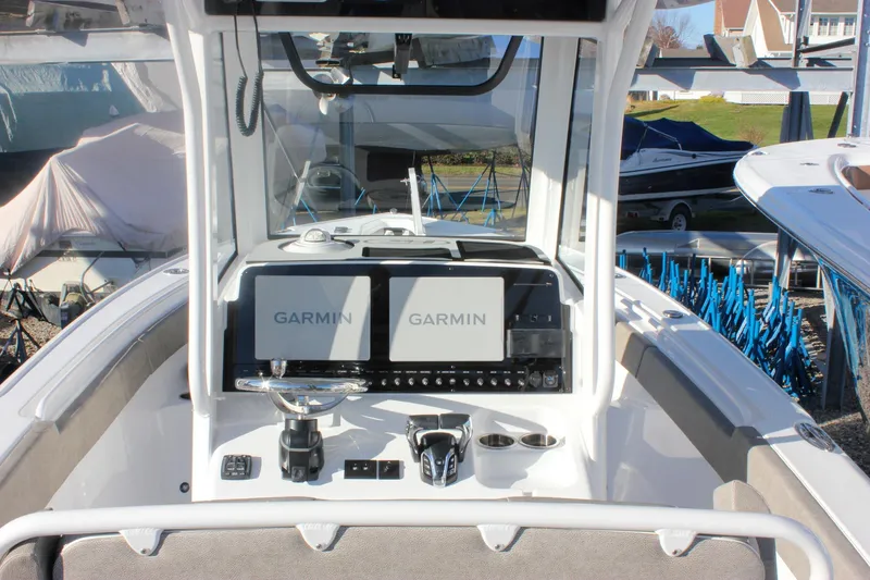 Slide: The Image of 2026 Sea Hunt Ultra 265 SE boat dashboard with dual Garmin displays. - 2