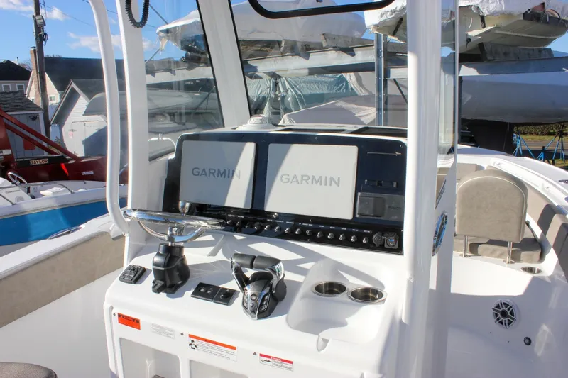 Slide: The Image of 2026 Sea Hunt Ultra 265 SE boat dashboard with Garmin navigation displays. - 22