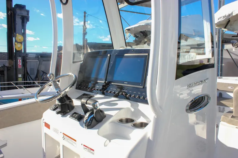 Slide: The Image of 2026 Sea Hunt Ultra 265 SE boat dashboard with modern controls and dual screens. - 27