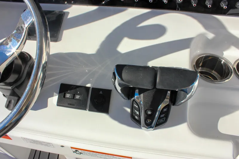Slide: The Image of Control panel of 2026 Sea Hunt Ultra 265 SE boat with steering wheel and throttle. - 29