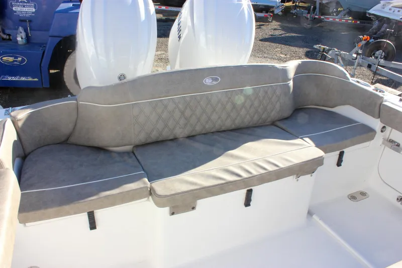 Slide: The Image of 2026 Sea Hunt Ultra 265 SE boat with cushioned seating and dual outboard motors. - 3