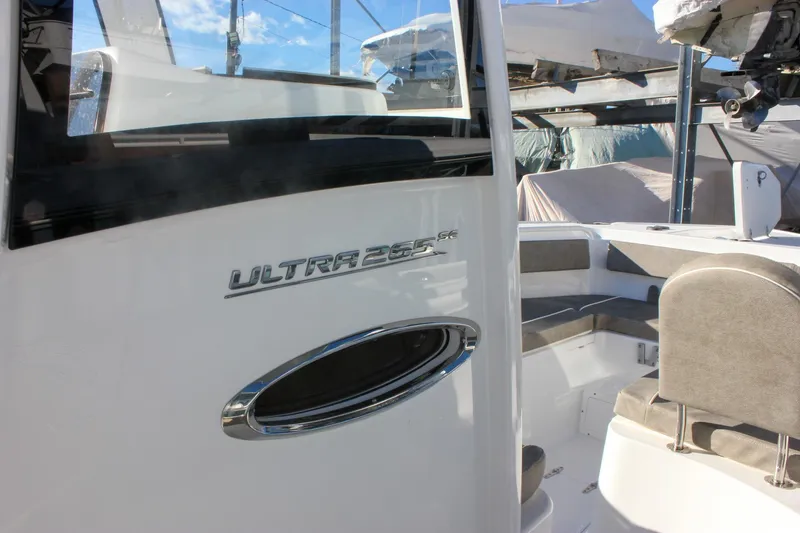 Slide: The Image of 2026 Sea Hunt Ultra 265 SE boat interior with seating and branding. - 33
