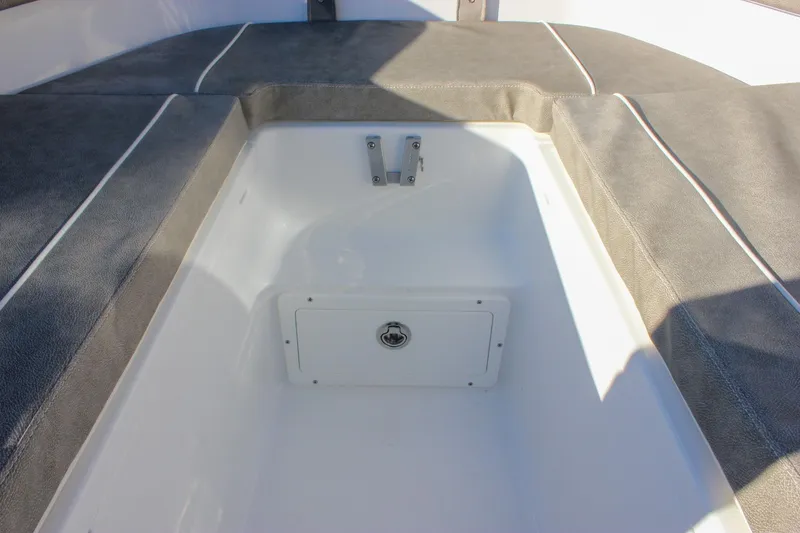 Slide: The Image of 2026 Sea Hunt Ultra 265 SE boat storage compartment with cushioned seating. - 38