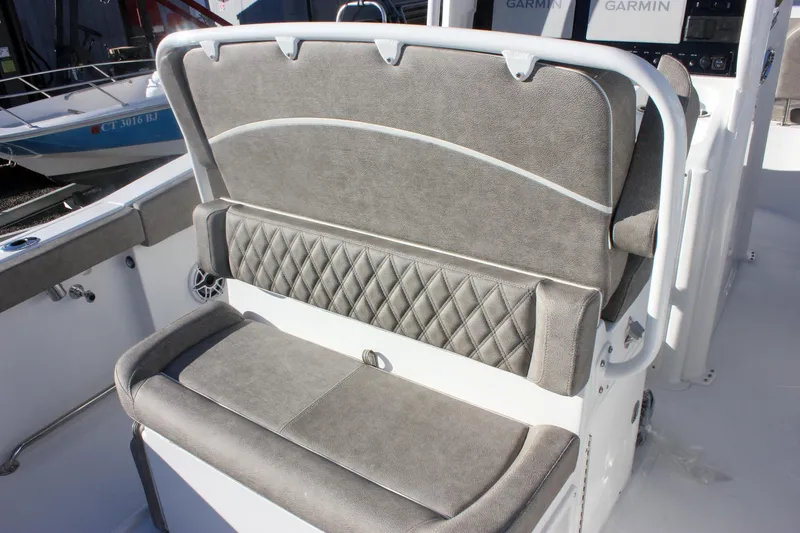 Slide: The Image of 2026 Sea Hunt Ultra 265 SE boat seating with gray upholstery and diamond stitching. - 4