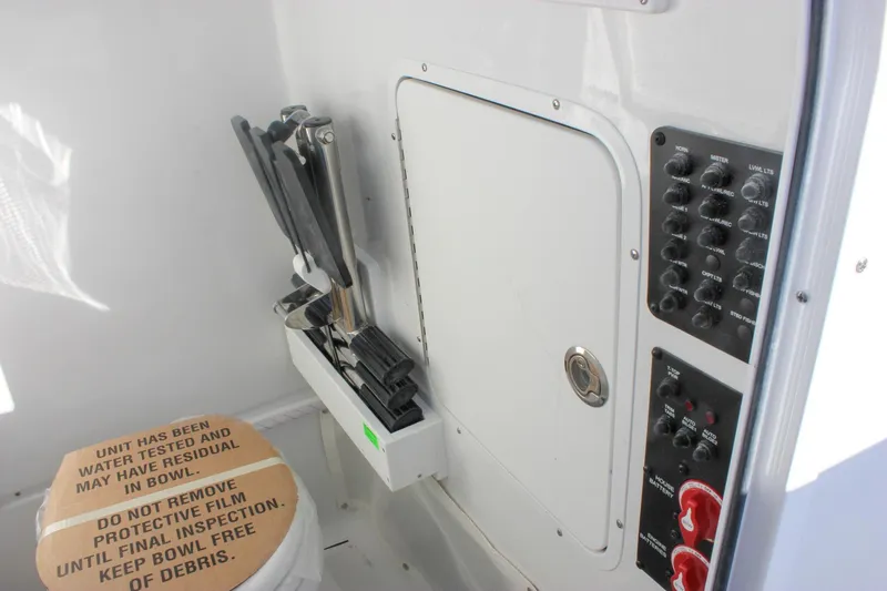 Slide: The Image of 2026 Sea Hunt Ultra 265 SE boat interior with control panel and storage compartment. - 45