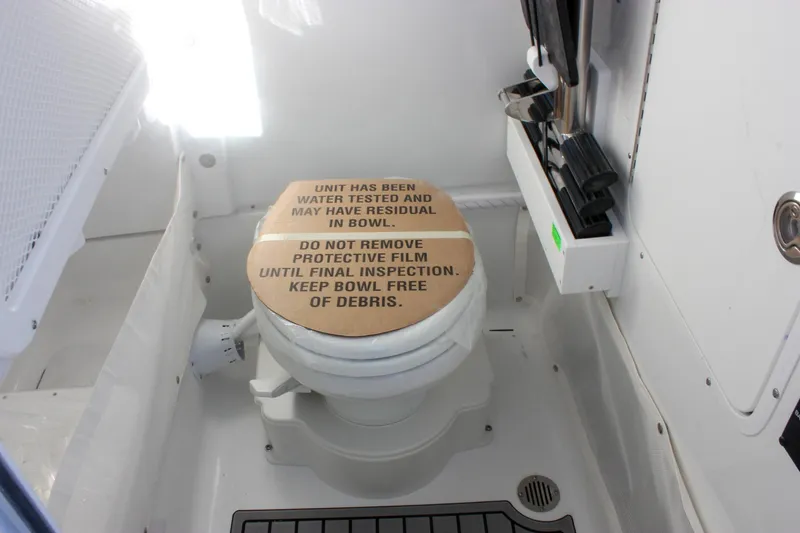 Slide: The Image of 2026 Sea Hunt Ultra 265 SE boat toilet with protective cover and cleaning instructions. - 46