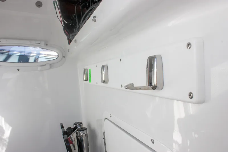 Slide: The Image of Interior view of 2026 Sea Hunt Ultra 265 SE boat with hooks and porthole. - 48