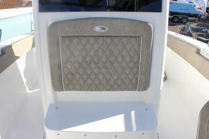 Slide: The Image of 2026 Sea Hunt Ultra 265 SE boat interior with cushioned seating and diamond pattern design. - 49