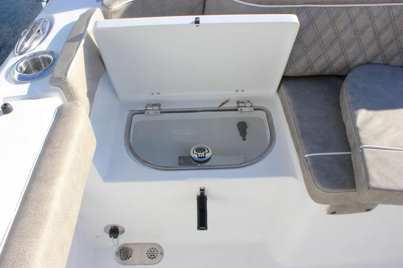 Slide: The Image of 2026 Sea Hunt Ultra 265 SE boat interior with storage compartment and seating. - 5