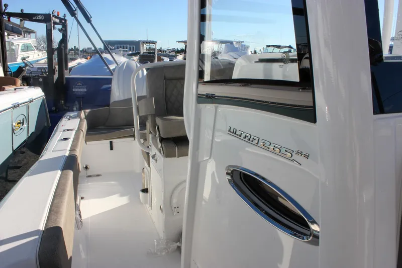Slide: The Image of 2026 Sea Hunt Ultra 265 SE boat interior with seating and logo detail. - 56