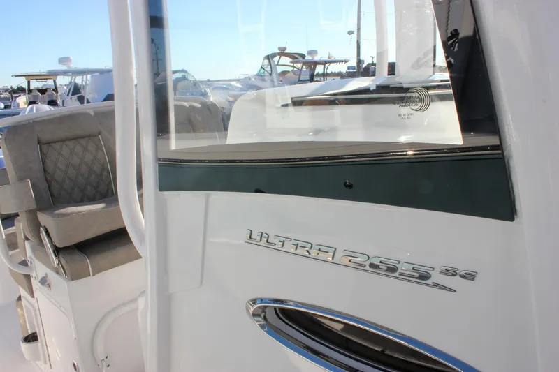 Slide: The Image of 2026 Sea Hunt Ultra 265 SE boat interior with seating and model emblem. - 57