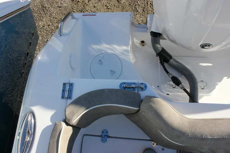 Slide: The Image of 2026 Sea Hunt Ultra 265 SE boat interior with seating and engine details. - 58