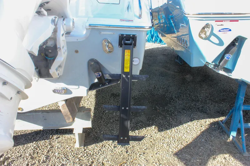 Slide: The Image of 2026 Sea Hunt Ultra 265 SE boat with ladder and motor details. - 59