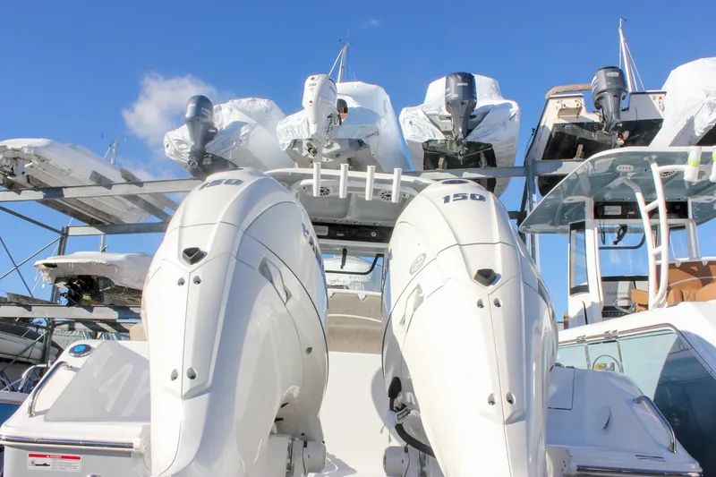 Slide: The Image of 2026 Sea Hunt Ultra 265 SE with dual outboard engines in a marina. - 61