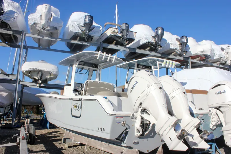 Slide: The Image of 2026 Sea Hunt Ultra 265 SE boat with Yamaha engines in storage facility. - 63