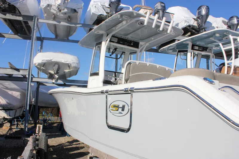 Slide: The Image of 2026 Sea Hunt Ultra 265 SE boat in storage, showcasing sleek design and modern features. - 64