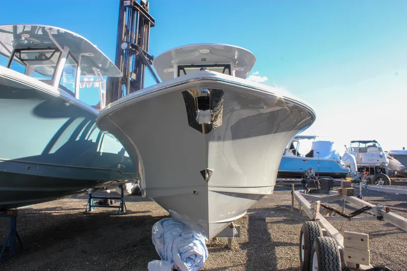 Slide: The Image of 2026 Sea Hunt Ultra 265 SE boat on display in a sunny marina setting. - 65