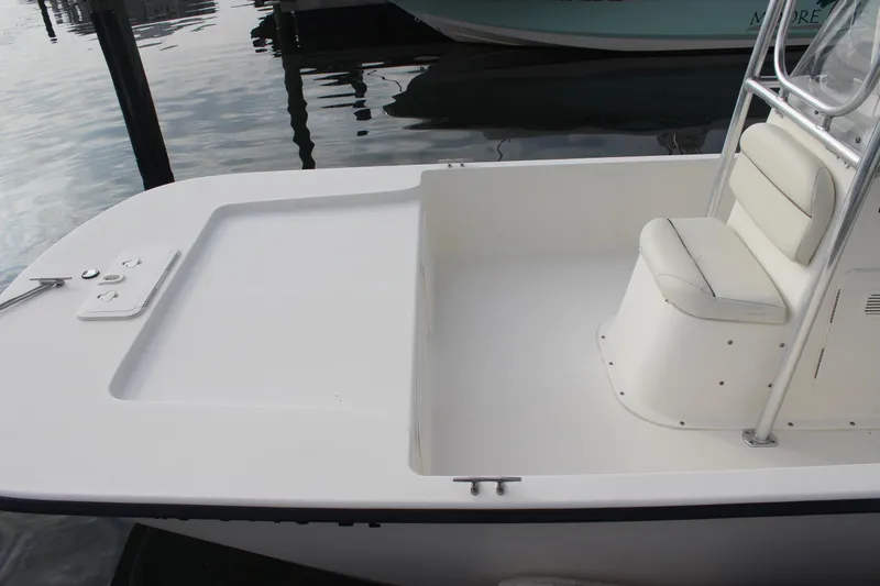 Slide: The Image of 2014 Key West 177 Skiff boat interior with seating and console, docked on calm water. - 10