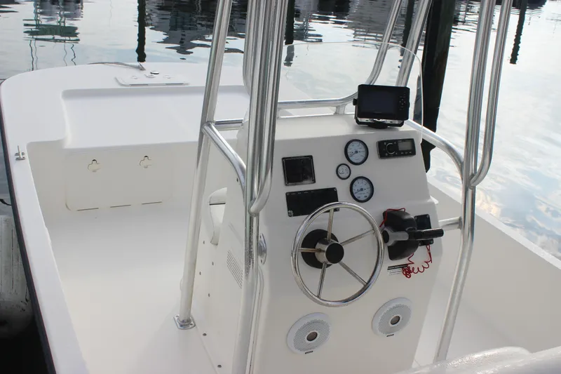 Slide: The Image of 2014 Key West 177 Skiff boat console with steering wheel and gauges. - 12