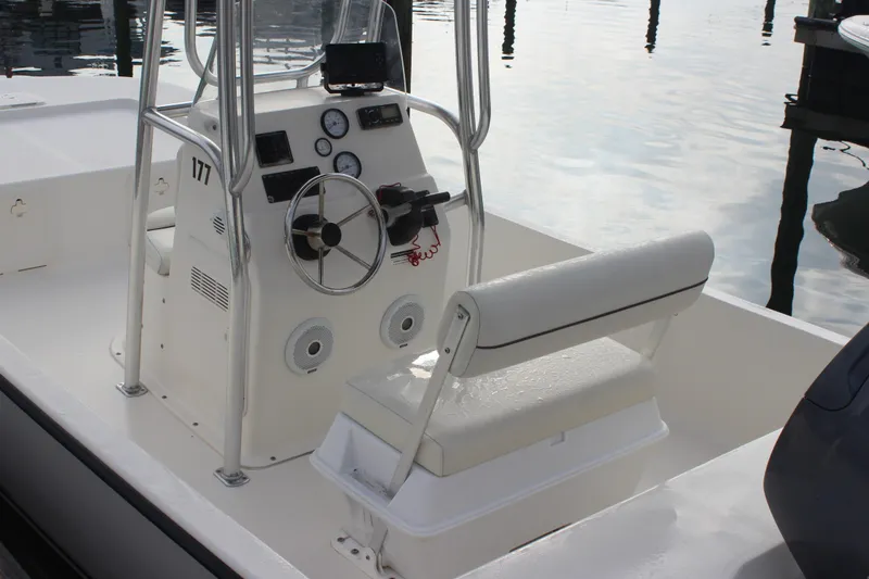 Slide: The Image of 2014 Key West 177 Skiff boat interior with steering console and seating. - 14