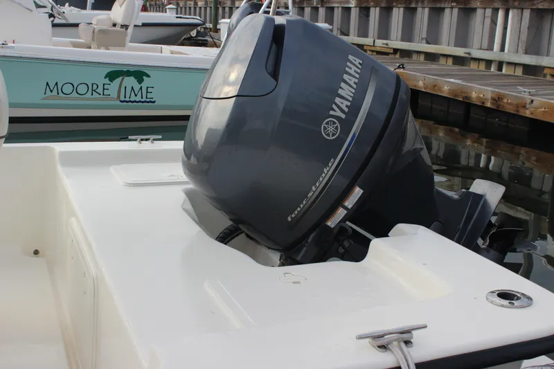 Slide: The Image of 2014 Key West 177 Skiff with Yamaha outboard motor docked at marina. - 18