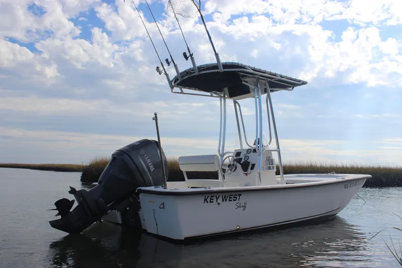 Slide: The Image of 2014 Key West 177 Skiff boat on calm water under a cloudy sky. - 3