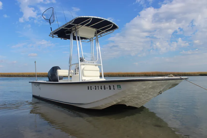 Slide: The Image of 2014 Key West 177 Skiff boat on calm water under a blue sky. - 8