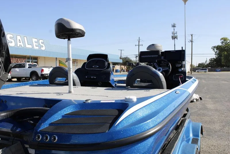 Slide: The Image of 2019 Nitro Z20 boat in blue, parked near a sales building. - 11