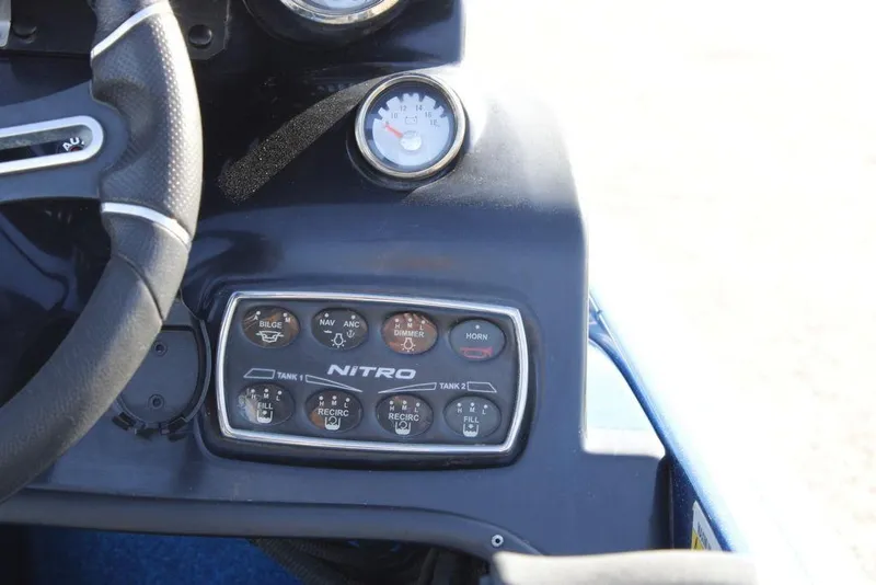 Slide: The Image of Control panel of a 2019 Nitro Z20 boat with steering wheel and switches. - 26