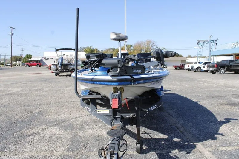 Slide: The Image of 2019 Nitro Z20 boat on trailer in parking lot, featuring Minn Kota trolling motor. - 9