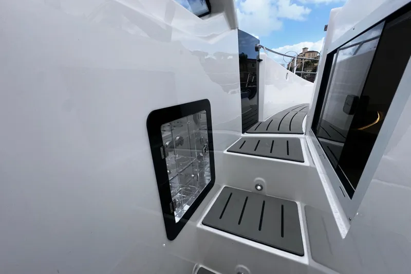 Slide: The Image of Interior of 2026 Granfort 37 GTX boat with modern kitchenette and seating area. - 32