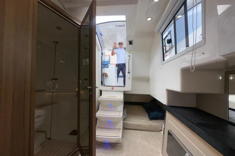 Slide: The Image of Granfort 37 GTX 2026 boat deck with speakers, docked near waterfront homes. - 37