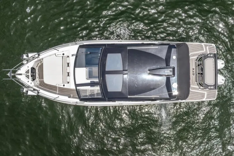 Slide: The Image of 2026 Granfort 37 GTX luxury boat docked by waterfront homes. - 4