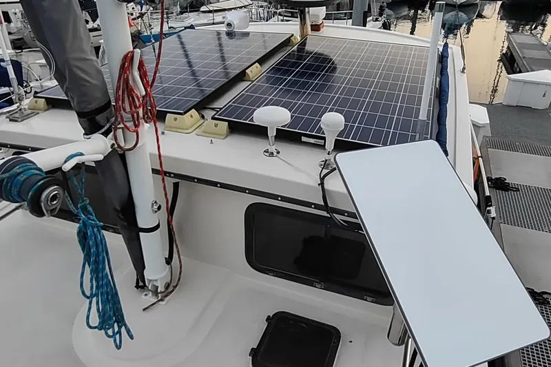 Slide: The Image of 1990 Nordic Tug 32 with solar panels on deck, docked at marina. - 13
