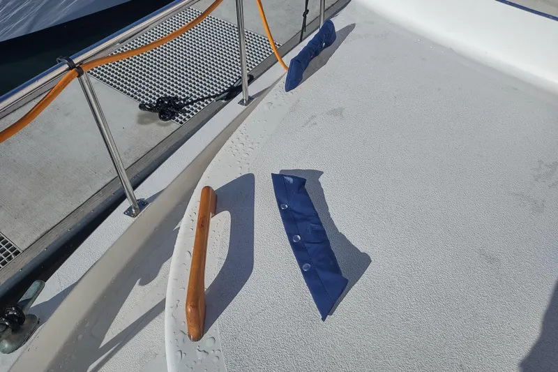 Slide: The Image of Deck of 1990 Nordic Tug 32 with railing and blue cover. - 15