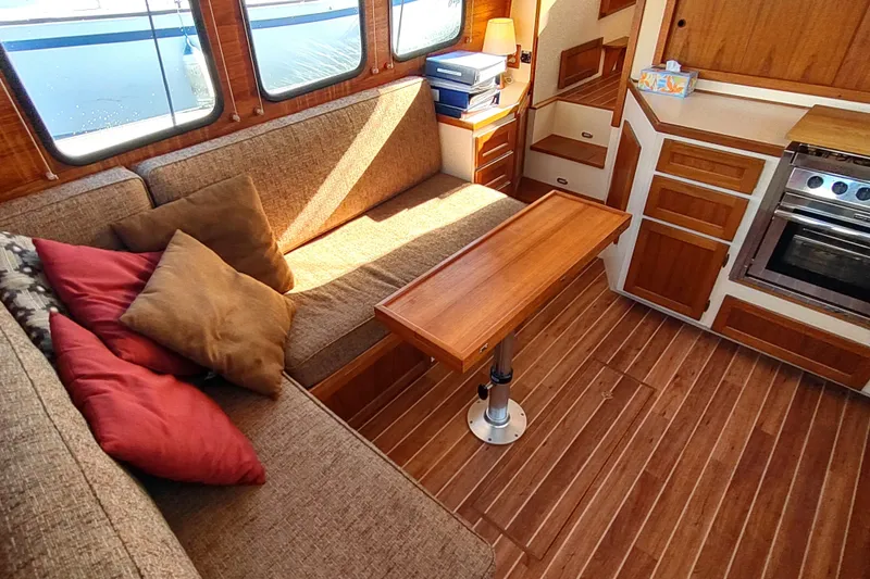 Slide: The Image of Cozy interior of a 1990 Nordic Tug 32 with wood accents and comfortable seating. - 20