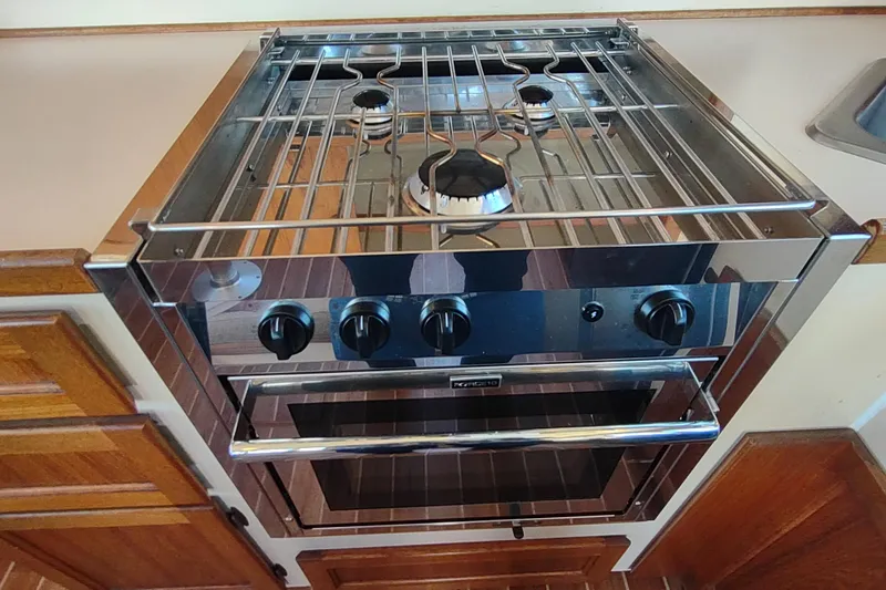 Slide: The Image of Stainless steel stove and oven in 1990 Nordic Tug 32 boat kitchen. - 25