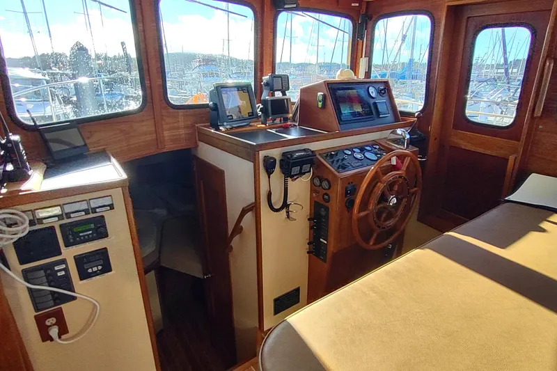 Slide: The Image of Cozy interior of a 1990 Nordic Tug 32 with wood accents and seating area. - 31