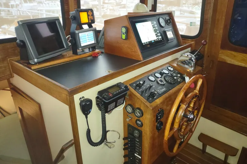 Slide: The Image of Interior of a 1990 Nordic Tug 32 with wooden accents and cushioned seating. - 34