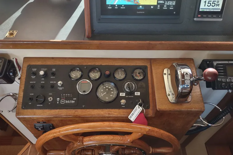 Slide: The Image of 1990 Nordic Tug 32 helm with navigation equipment and wooden steering wheel. - 39