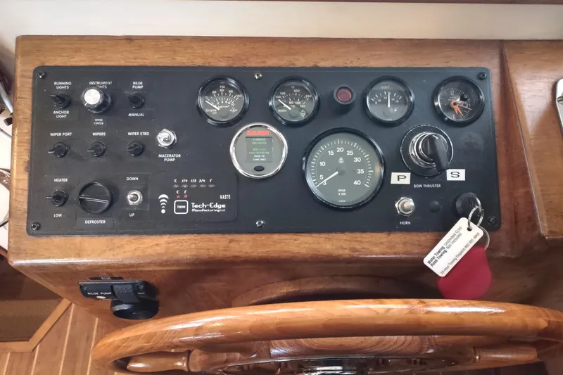 Slide: The Image of Control panel of a 1990 Nordic Tug 32 with gauges and navigation equipment. - 40
