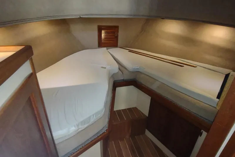 Slide: The Image of 1990 Nordic Tug 32 interior cabin with twin beds and wooden accents. - 46