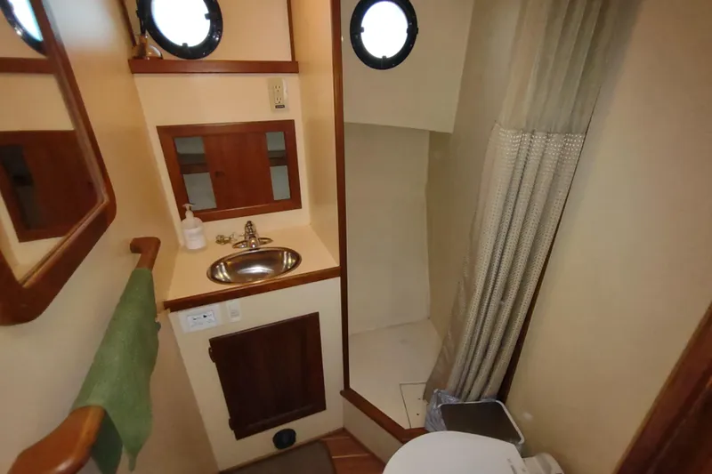 Slide: The Image of Cozy cabin interior of 1990 Nordic Tug 32 with wooden accents and bedding. - 47