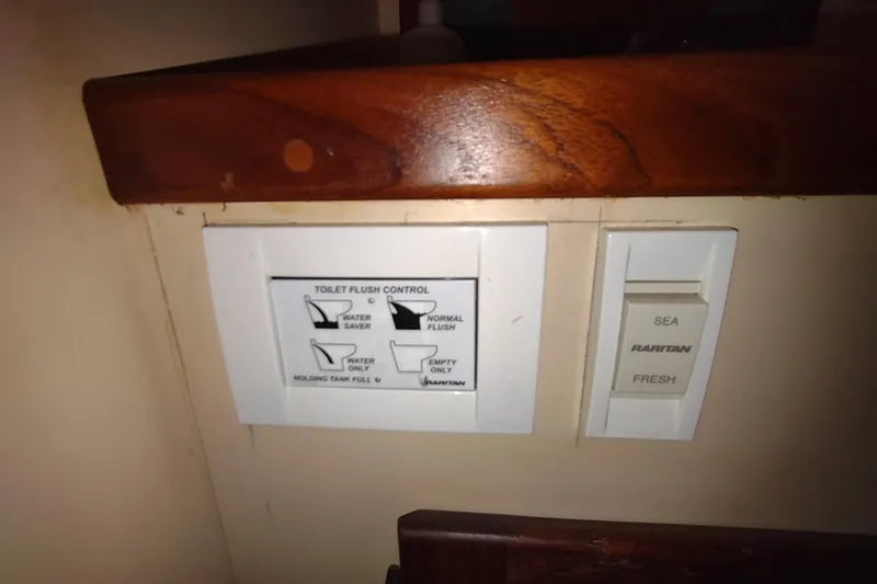 Slide: The Image of Bathroom interior of a 1990 Nordic Tug 32, featuring sink, mirror, and shower area. - 49