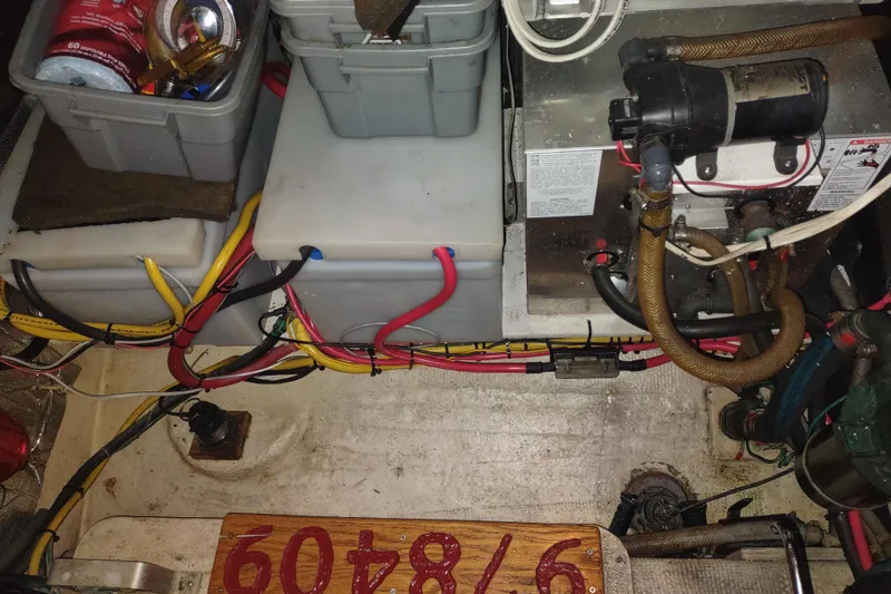 Slide: The Image of Deck of a 1990 Nordic Tug 32 with coiled orange hose and blue cover. - 56