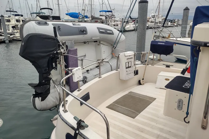 Slide: The Image of 1990 Nordic Tug 32 with dinghy and outboard motor at marina dock. - 6