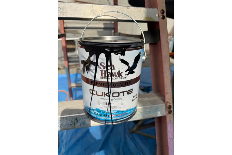 Slide: The Image of Outboard motor on a 1990 Nordic Tug 32, featuring Suzuki four-stroke engine. - 64