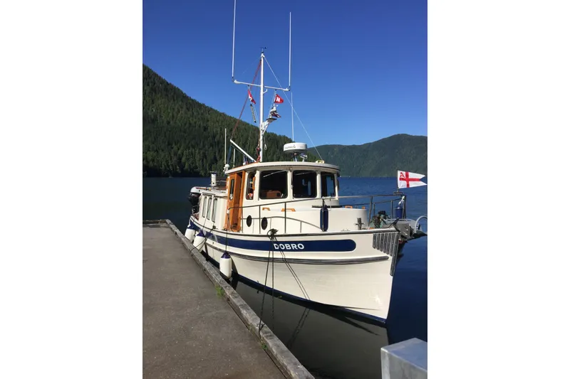 Slide: The Image of Propeller of 1990 Nordic Tug 32 boat on blue tarp, with vehicles in background. - 69