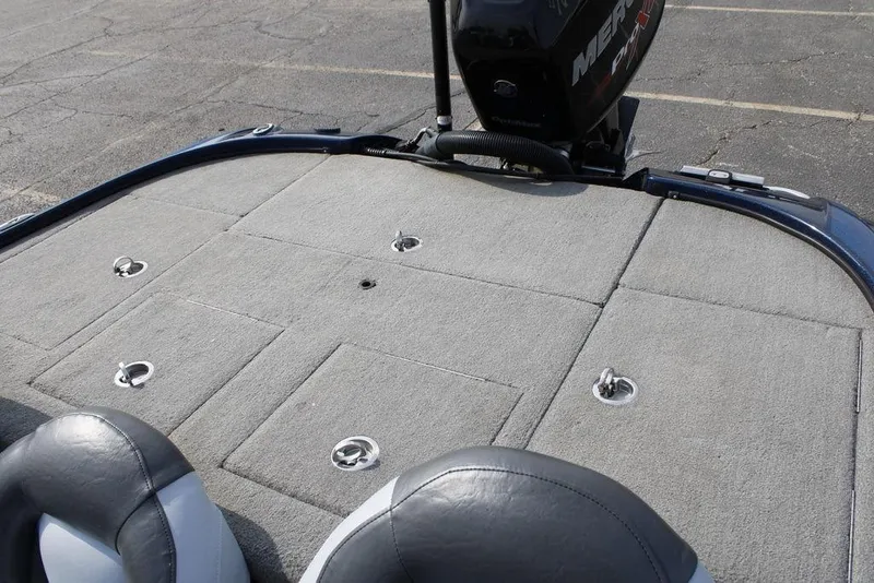 Slide: The Image of 2015 Nitro Z-9 boat deck with Mercury engine, featuring gray carpet and storage compartments. - 25